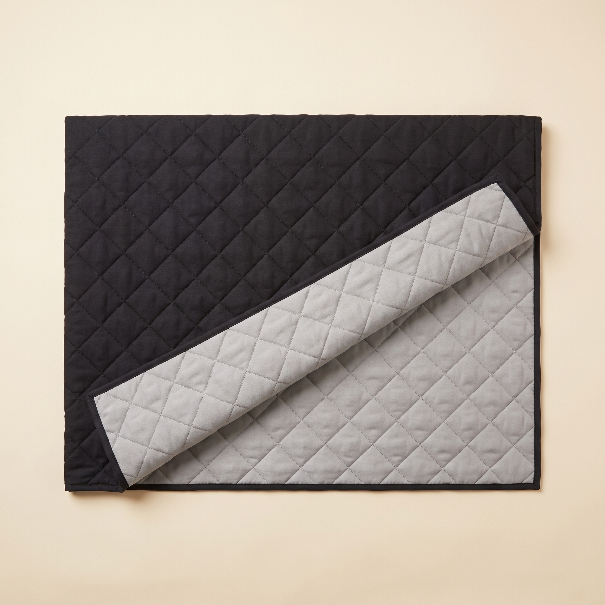 Reversible cover folded to show the dark top side and light grey reverse